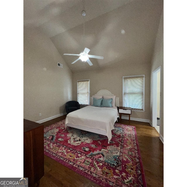 bedroom with ceiling fan, high vaulted ceiling, and dark hardwood / wood-style floors