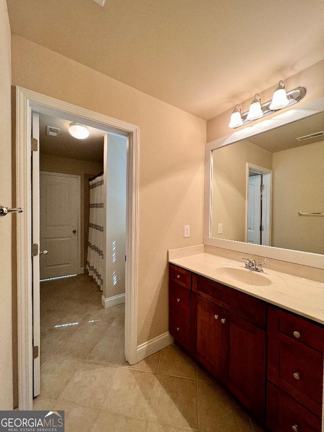 bathroom featuring tile patterned flooring and vanity