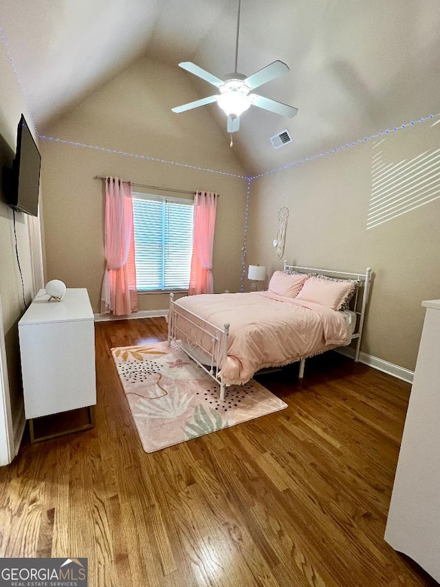 bedroom featuring hardwood / wood-style floors, ceiling fan, and vaulted ceiling