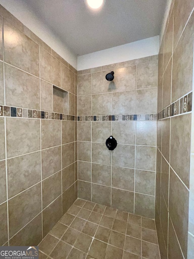 bathroom with tiled shower