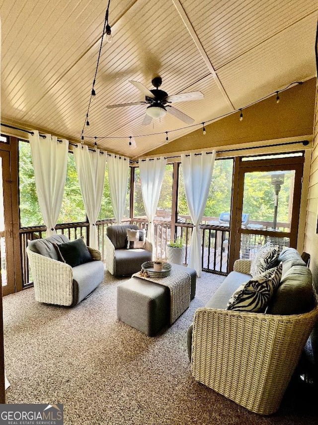 sunroom with ceiling fan, wood ceiling, and vaulted ceiling