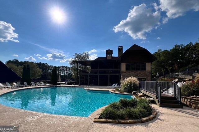 view of pool with a wooden deck