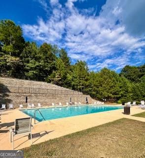 view of swimming pool with a patio area