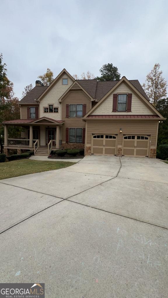 view of front facade featuring a porch and a garage