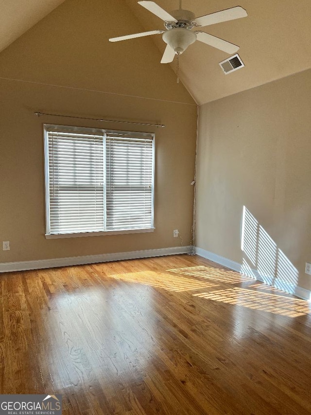 unfurnished room featuring vaulted ceiling, ceiling fan, and a healthy amount of sunlight