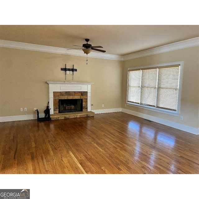 unfurnished living room with crown molding, a fireplace, ceiling fan, and hardwood / wood-style flooring