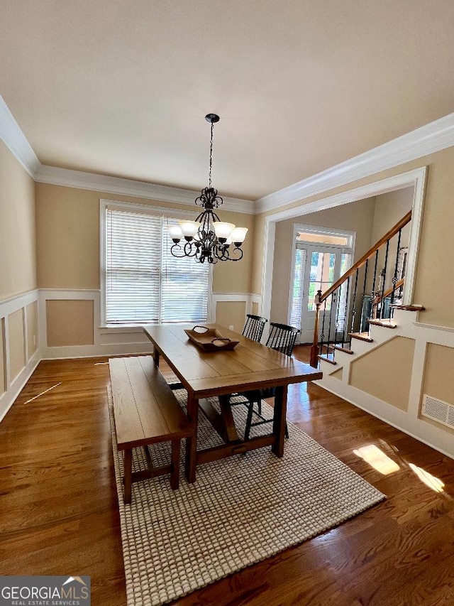 dining area with a chandelier, dark hardwood / wood-style floors, and ornamental molding