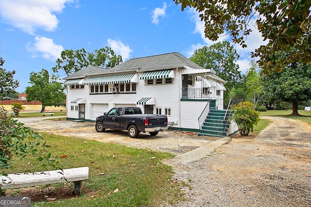 exterior space featuring a garage and a front lawn