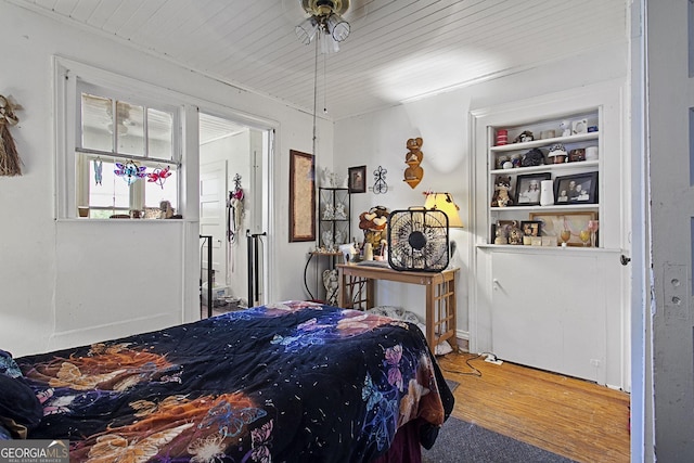 bedroom with wooden ceiling and wood finished floors