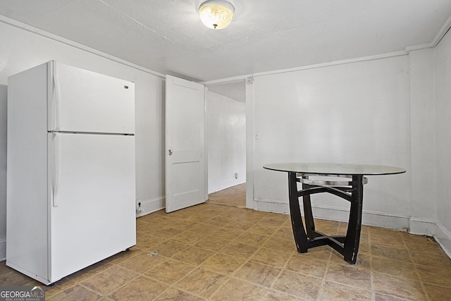 dining space with a textured ceiling