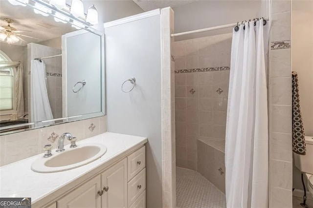 bathroom featuring ceiling fan, vanity, and a shower with shower curtain