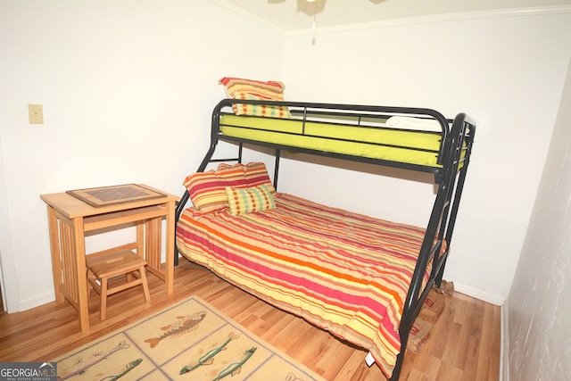 bedroom featuring hardwood / wood-style flooring and crown molding