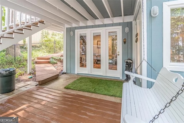 view of exterior entry with french doors and a deck