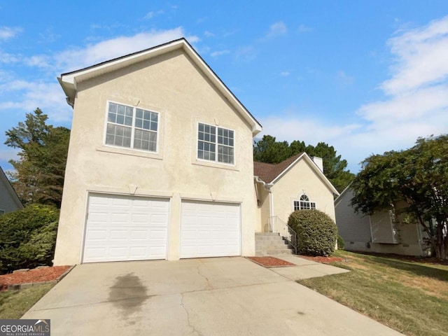 front facade with a front yard and a garage