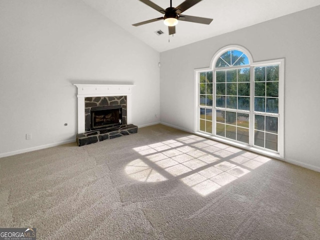 unfurnished living room featuring lofted ceiling, ceiling fan, light carpet, and a fireplace