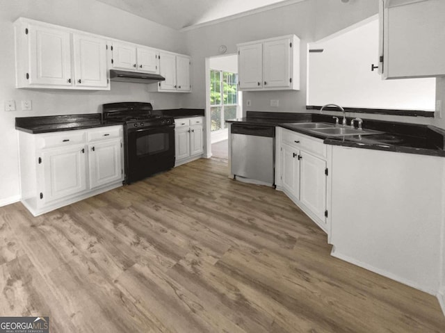 kitchen featuring light wood-type flooring, stainless steel dishwasher, white cabinetry, vaulted ceiling, and black range with gas stovetop