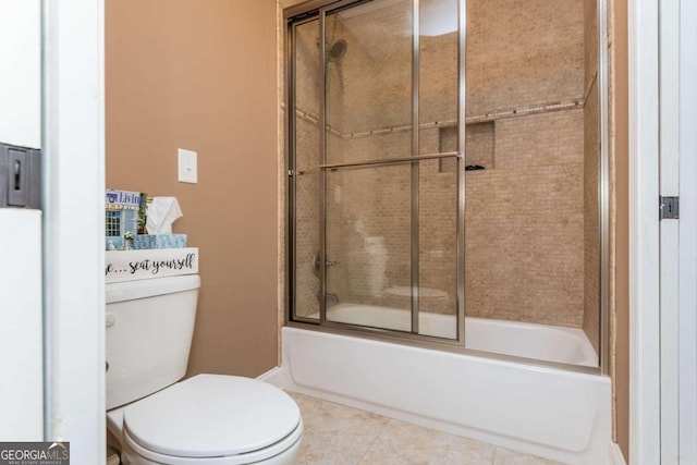 bathroom with toilet, enclosed tub / shower combo, and tile patterned flooring