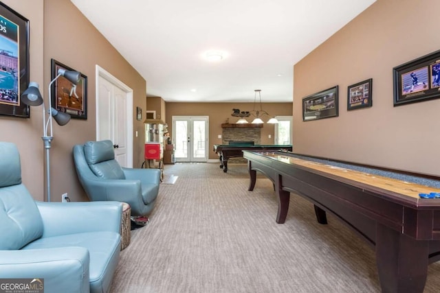 rec room featuring billiards, carpet flooring, french doors, and a fireplace