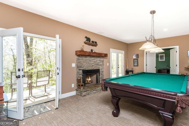 game room featuring billiards, carpet, a stone fireplace, and french doors