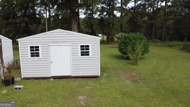 view of outbuilding featuring a lawn