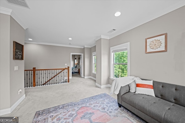 carpeted living room featuring ornamental molding