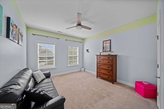 interior space featuring light carpet and ceiling fan