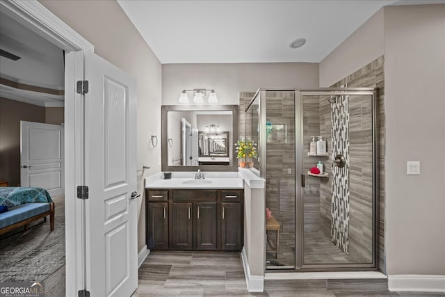 bathroom featuring vanity and a shower with door