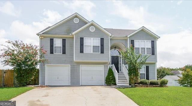 split foyer home featuring a front yard and a garage