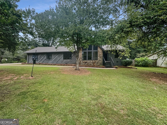 rear view of house with a lawn