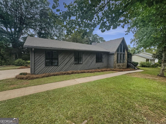 view of front of house with a front lawn, crawl space, and a chimney