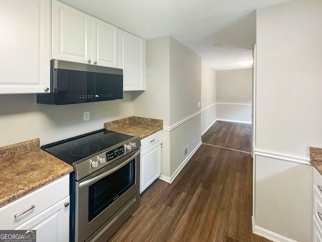 kitchen featuring white cabinetry, dark hardwood / wood-style flooring, stainless steel appliances, and a textured ceiling