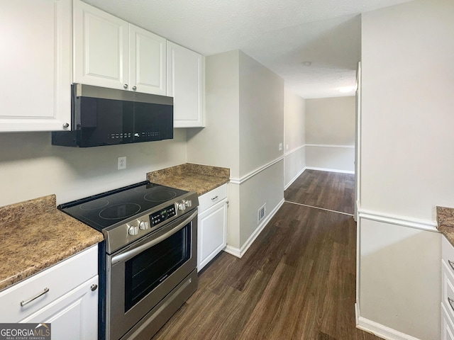 kitchen featuring white cabinets, baseboards, dark wood-style flooring, and appliances with stainless steel finishes