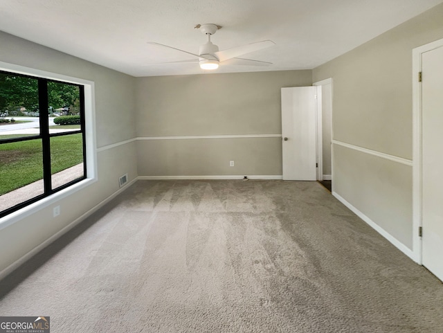 unfurnished room featuring ceiling fan and light colored carpet