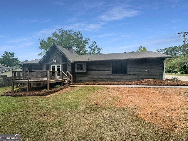 back of house with a wooden deck and a yard