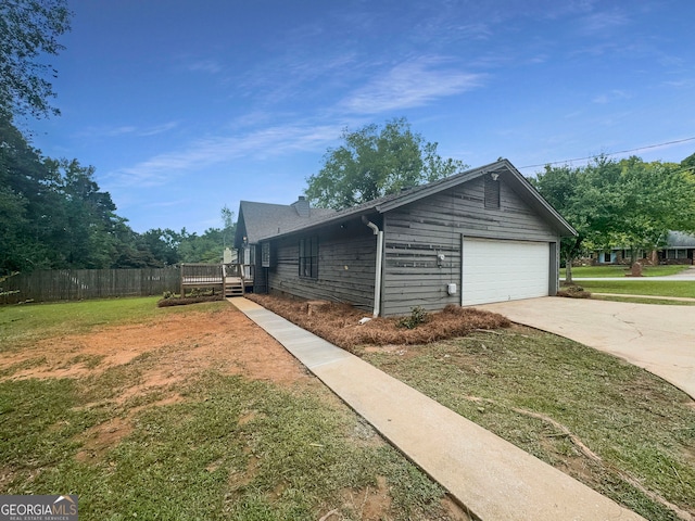 view of property exterior with a garage and a yard