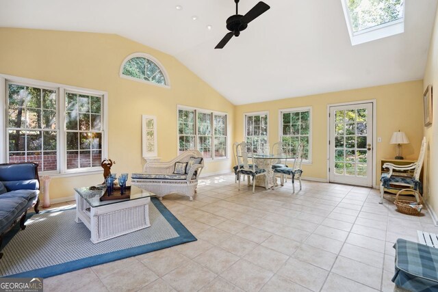 living room featuring high vaulted ceiling, ceiling fan, plenty of natural light, and light tile patterned flooring