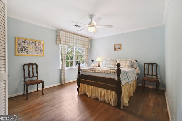 bedroom featuring ceiling fan, ornamental molding, and dark hardwood / wood-style flooring