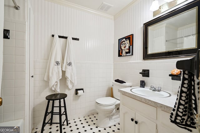 bathroom featuring vanity, toilet, walk in shower, and tile walls