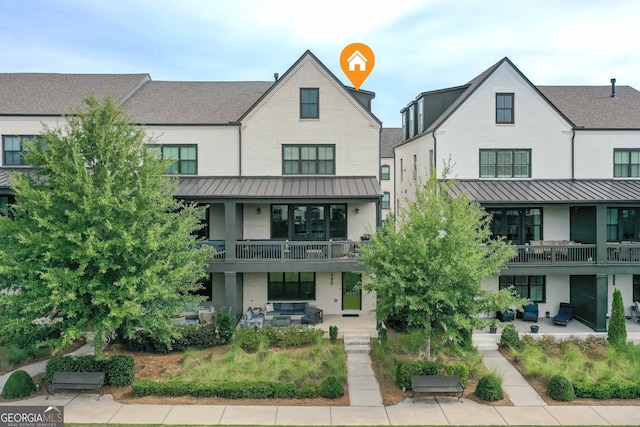 exterior space with a balcony and a patio