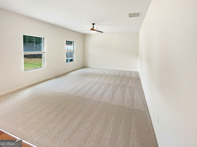 carpeted spare room with lofted ceiling and ceiling fan