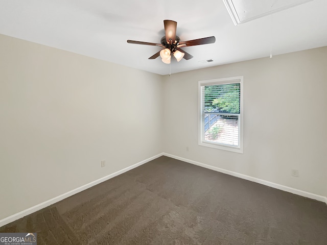 unfurnished room featuring dark carpet and ceiling fan