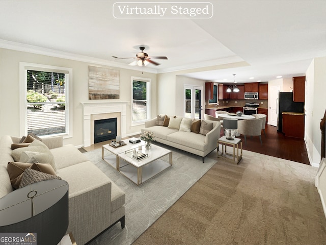 living room with ceiling fan, hardwood / wood-style flooring, and ornamental molding