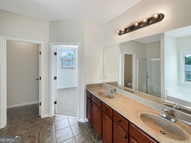 full bathroom with plus walk in shower, tile patterned flooring, toilet, and vanity