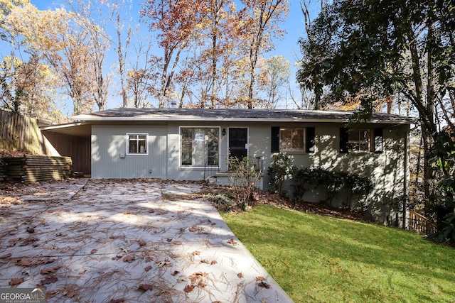 ranch-style house with a front lawn and a carport