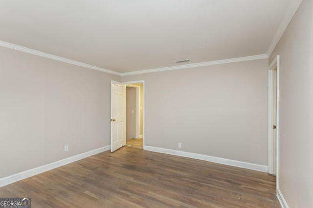 spare room featuring hardwood / wood-style floors and crown molding