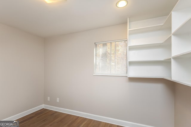 empty room with hardwood / wood-style floors