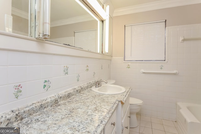 bathroom with vanity, tile patterned floors, toilet, ornamental molding, and a tub to relax in