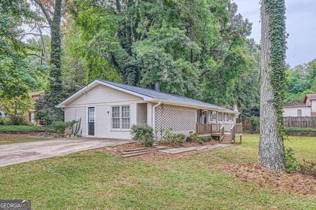 ranch-style house featuring a wooden deck and a front yard