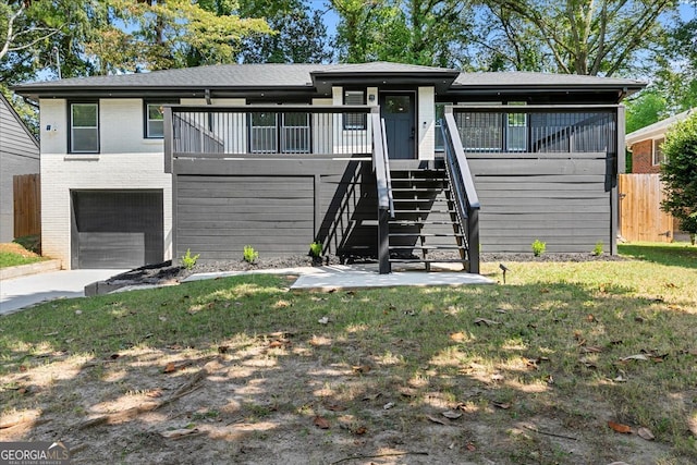 view of front of house with a garage and a front lawn