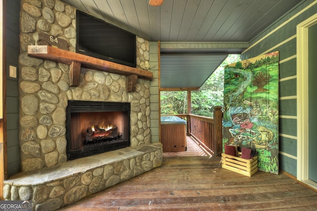 wooden terrace with a stone fireplace